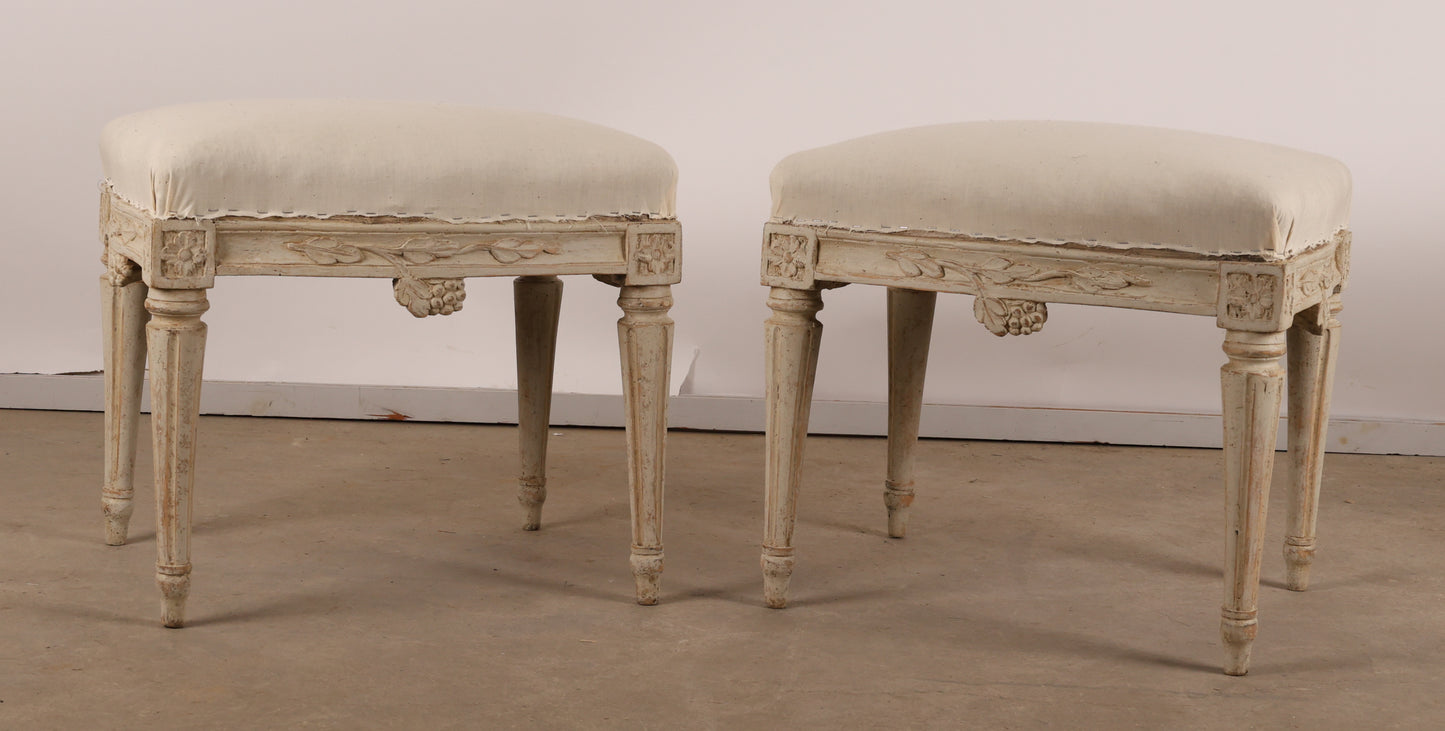 Pair of 18th Century Gustavian Stools signed Johan Erik Höglander with carved decorations of grapes, branches and corner rosettes. The legs are carved with flutings