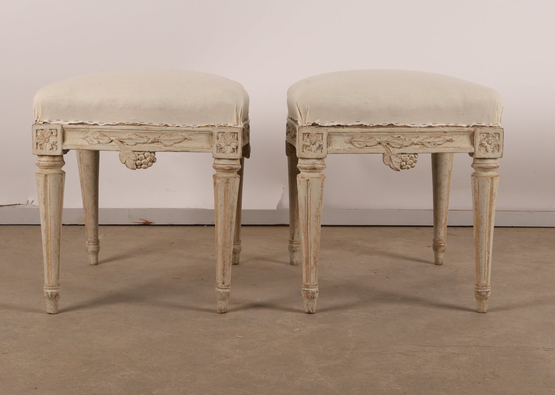 Pair of 18th Century Gustavian Antique Stools signed Johan Erik Höglander with carved decorations of grapes, branches and corner rosettes. The legs are carved with flutings