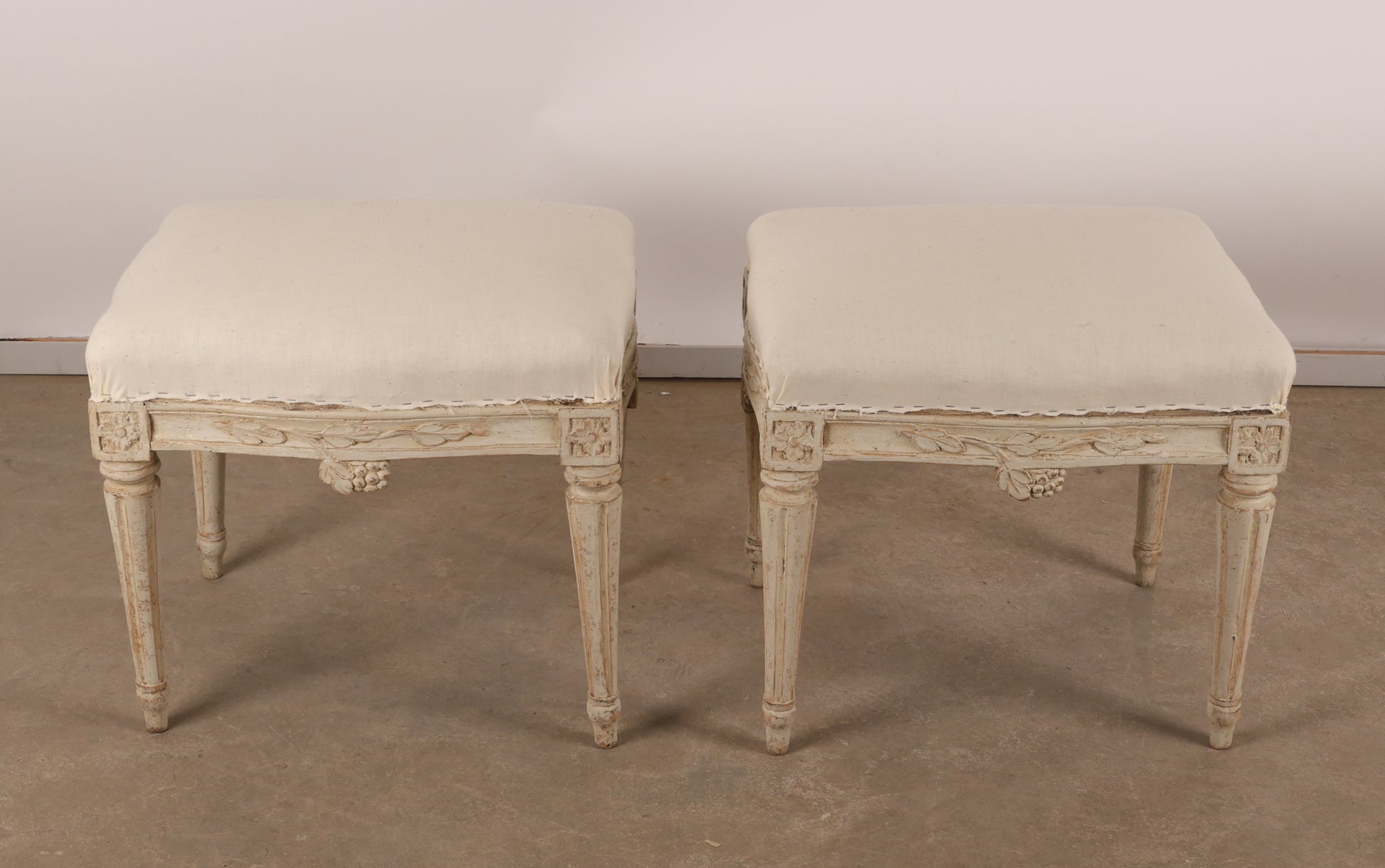 Above view of Pair of 18th Century Gustavian Stools signed Johan Erik Höglander with carved decorations of grapes, branches and corner rosettes. The legs are carved with flutings. 