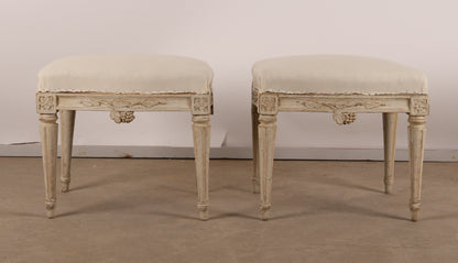 Pair of 18th Century Gustavian Stools signed Johan Erik Höglander with carved decorations of grapes, branches and corner rosettes. The legs are carved with flutings. 